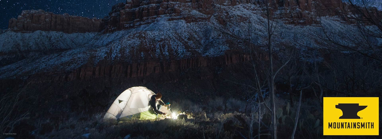 Man in Mountainsmith tent in mountains