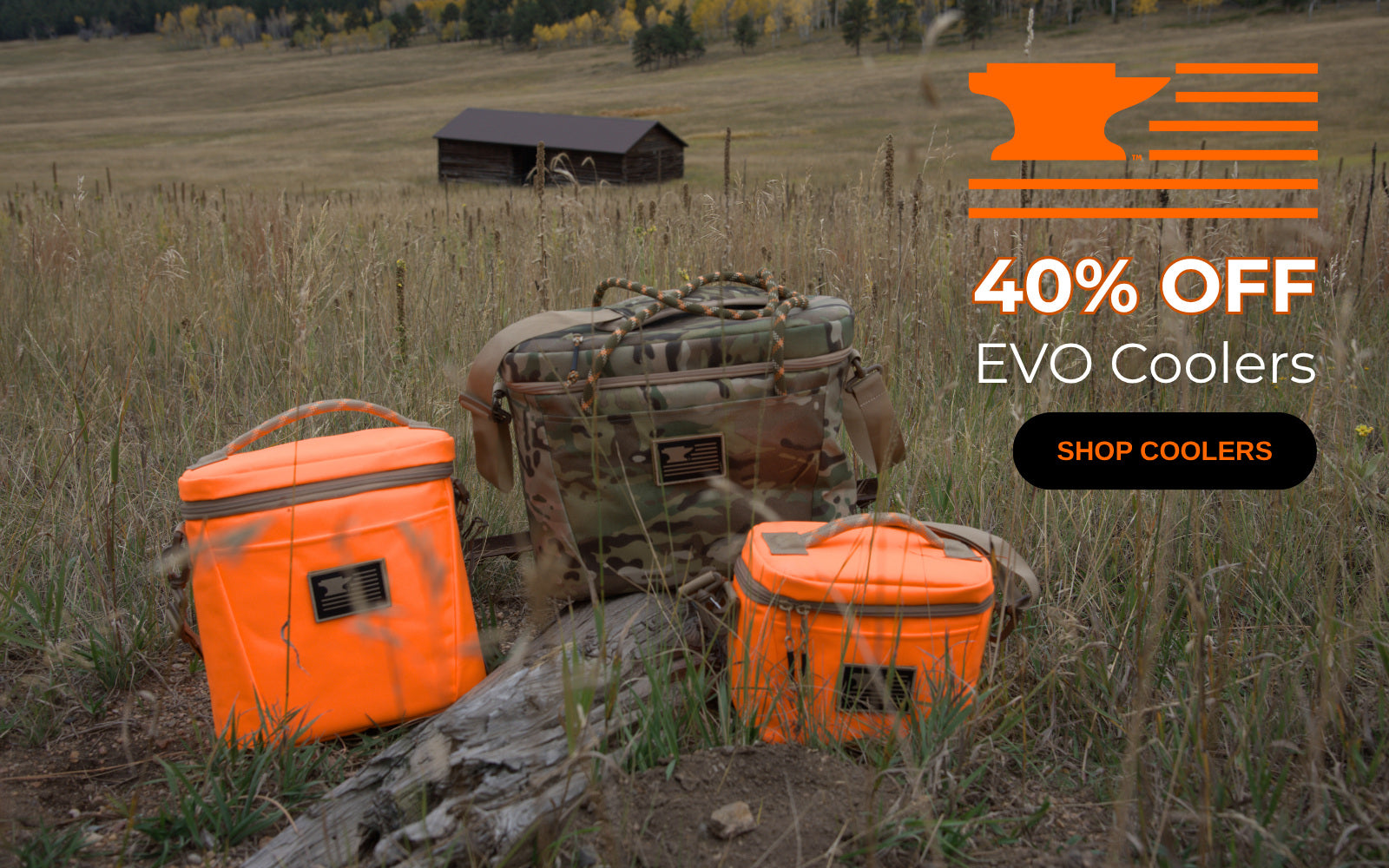 3 mountainsmith coolers in a field with a barn in the background
