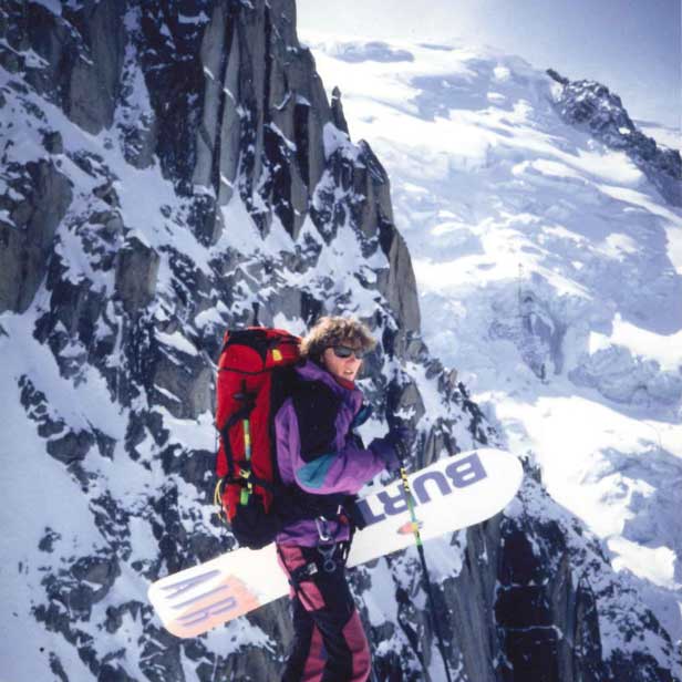 Man with snow board - hiking backpack
